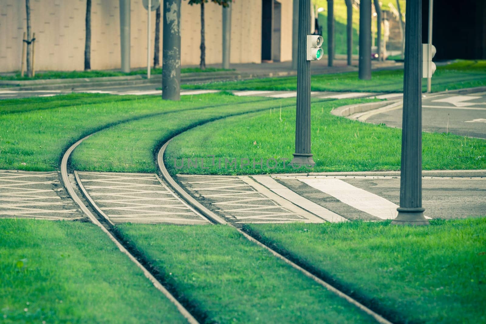 Tram rails covered with green grass lawn in Bilbao, Spain