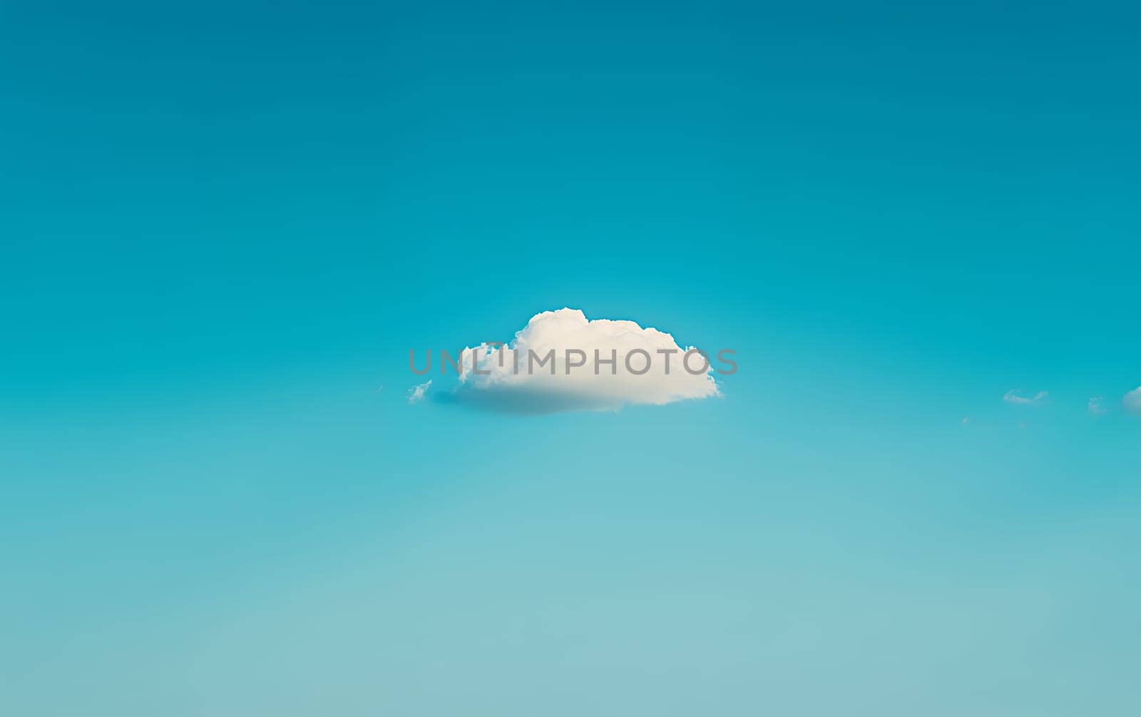 A single fluffy white cloud floats in a vast expanse of vibrant turquoise sky, offering ample copy space for text or design elements.