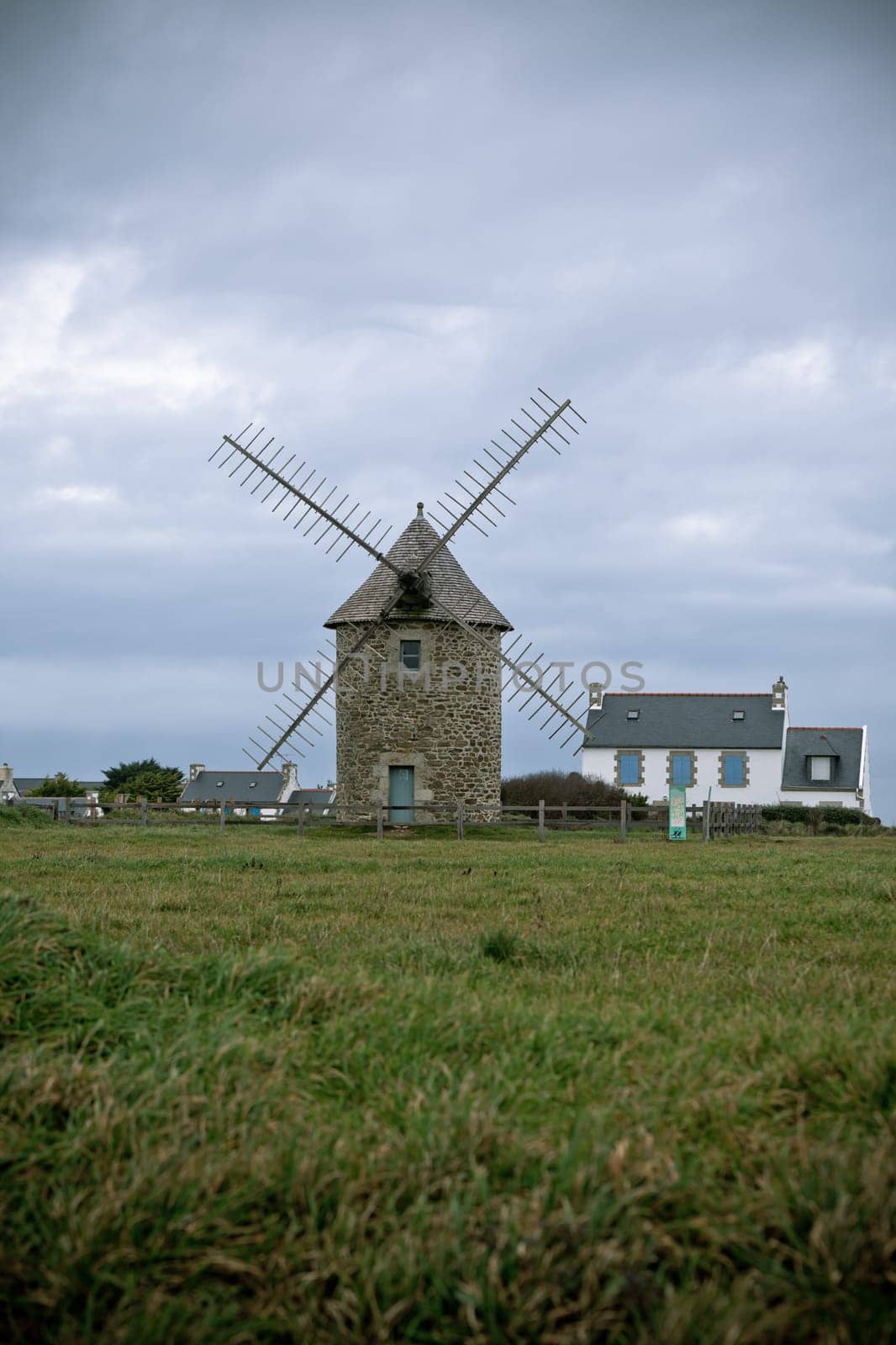 Dull Landscape with Old windmill in Brittany, Western France. Toned and vignetted image