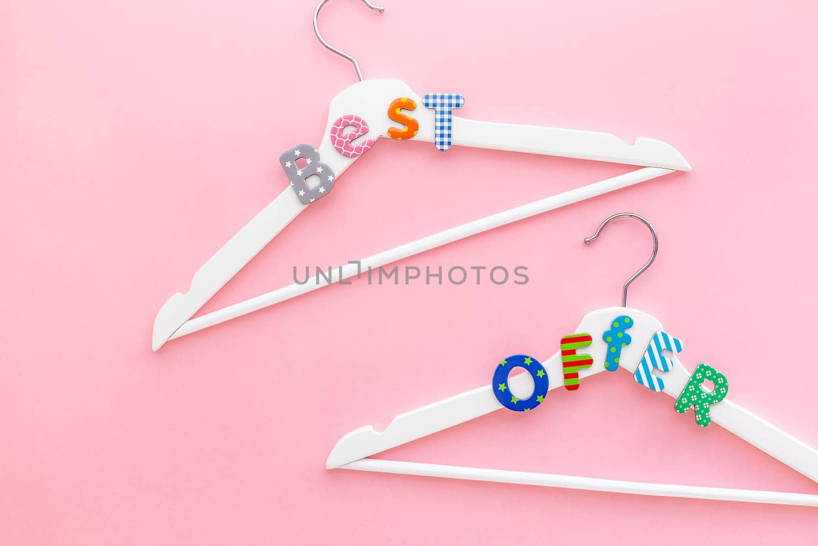 Creative top view flat lay white wooden hangers best offer pastel pink background copy space minimalism style. Template fashion feminine blog social media sale store promo design shopping concept