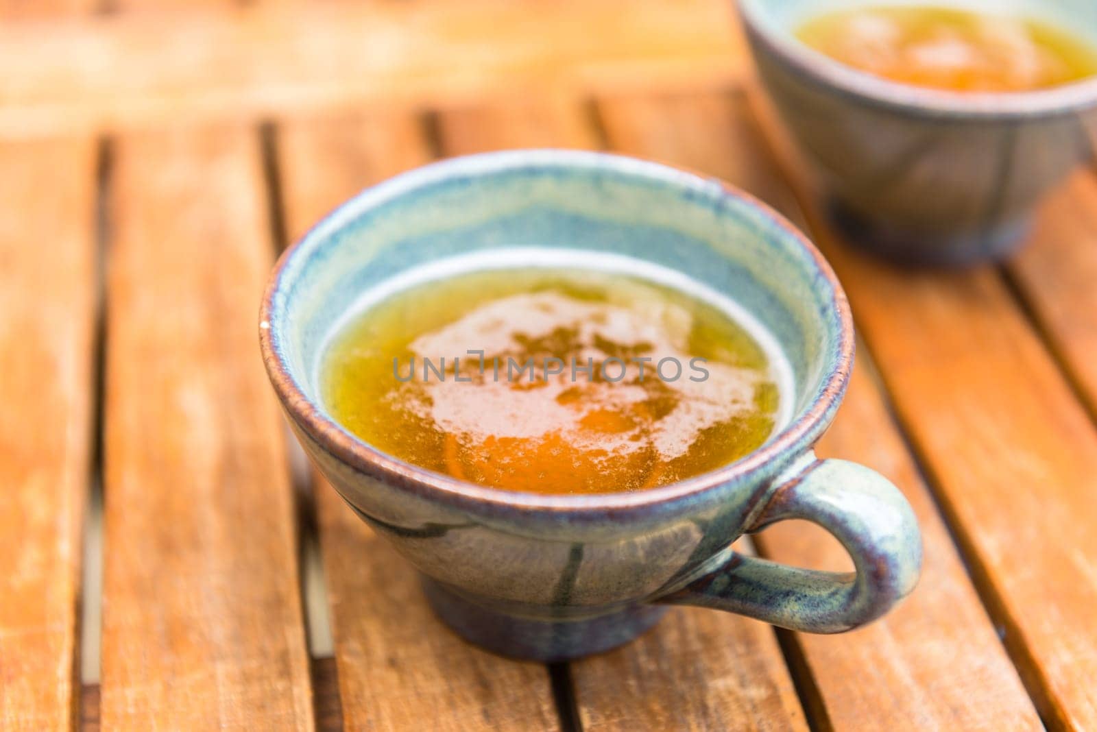 Norman apple cider in a typical ceramic cups. Shot with a selective focus