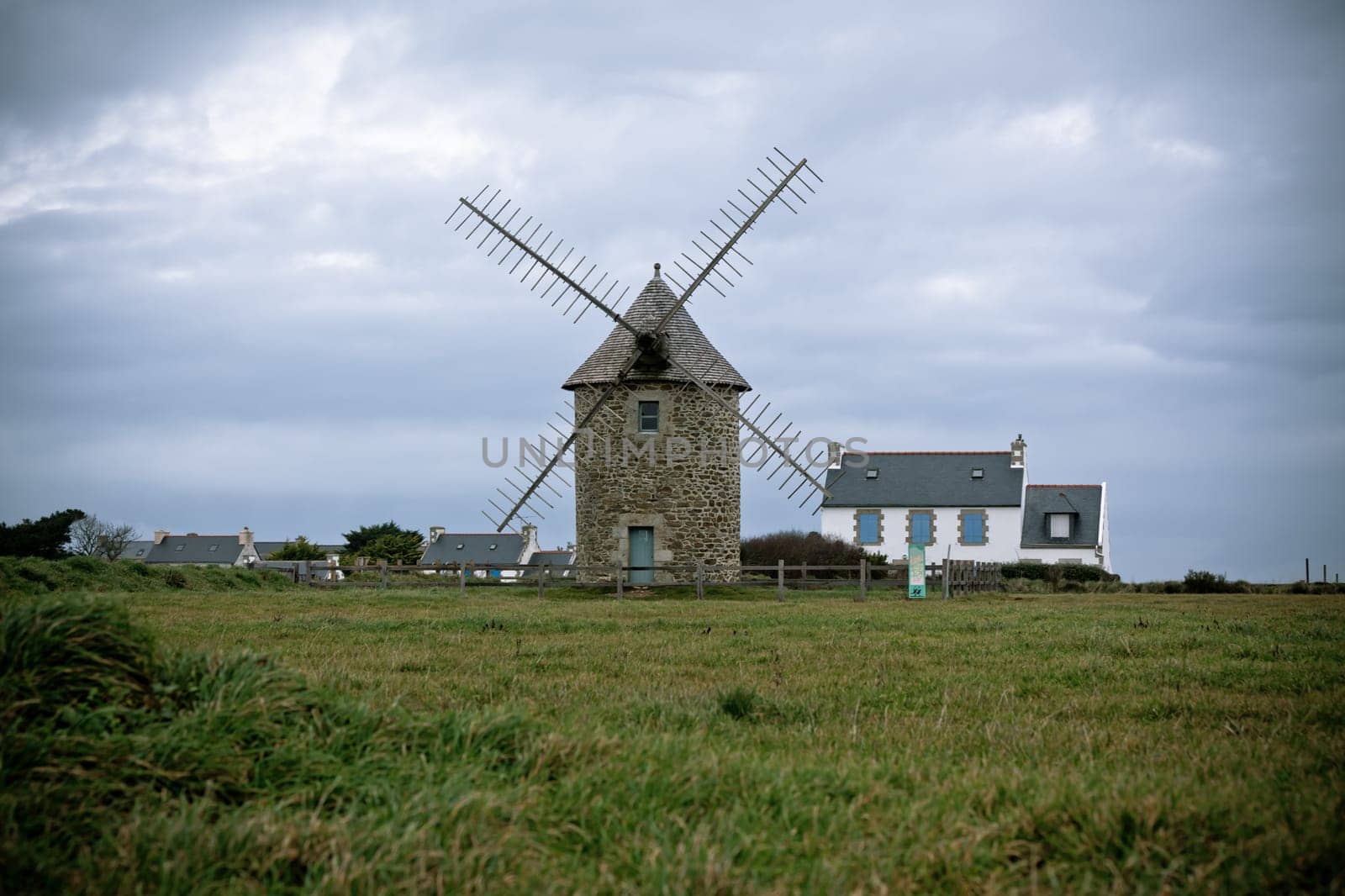 Dull Landscape with Old windmill in Brittany, Western France. Toned image