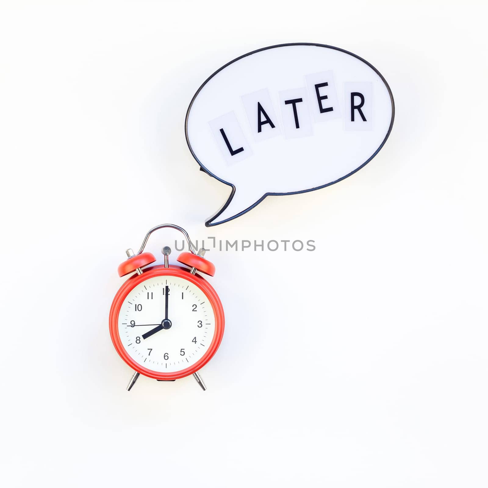 Creative top view flat lay of alarm clock with message Later copy space white background minimal style. Concept of procrastination, time management in business and life