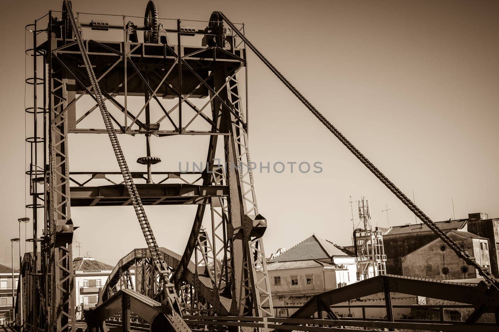 Metal structure elevation bridge over Sado river. Alcacer do Sal, Portugal. Sepia filtered shot
