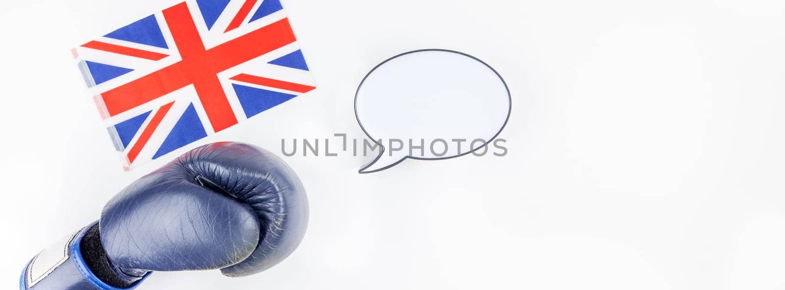 Creative top view flat lay of boxing glove with Great Britain flag with empty bubble lightbox mockup and copy space on white background minimal style. Concept of politic fights in Europe