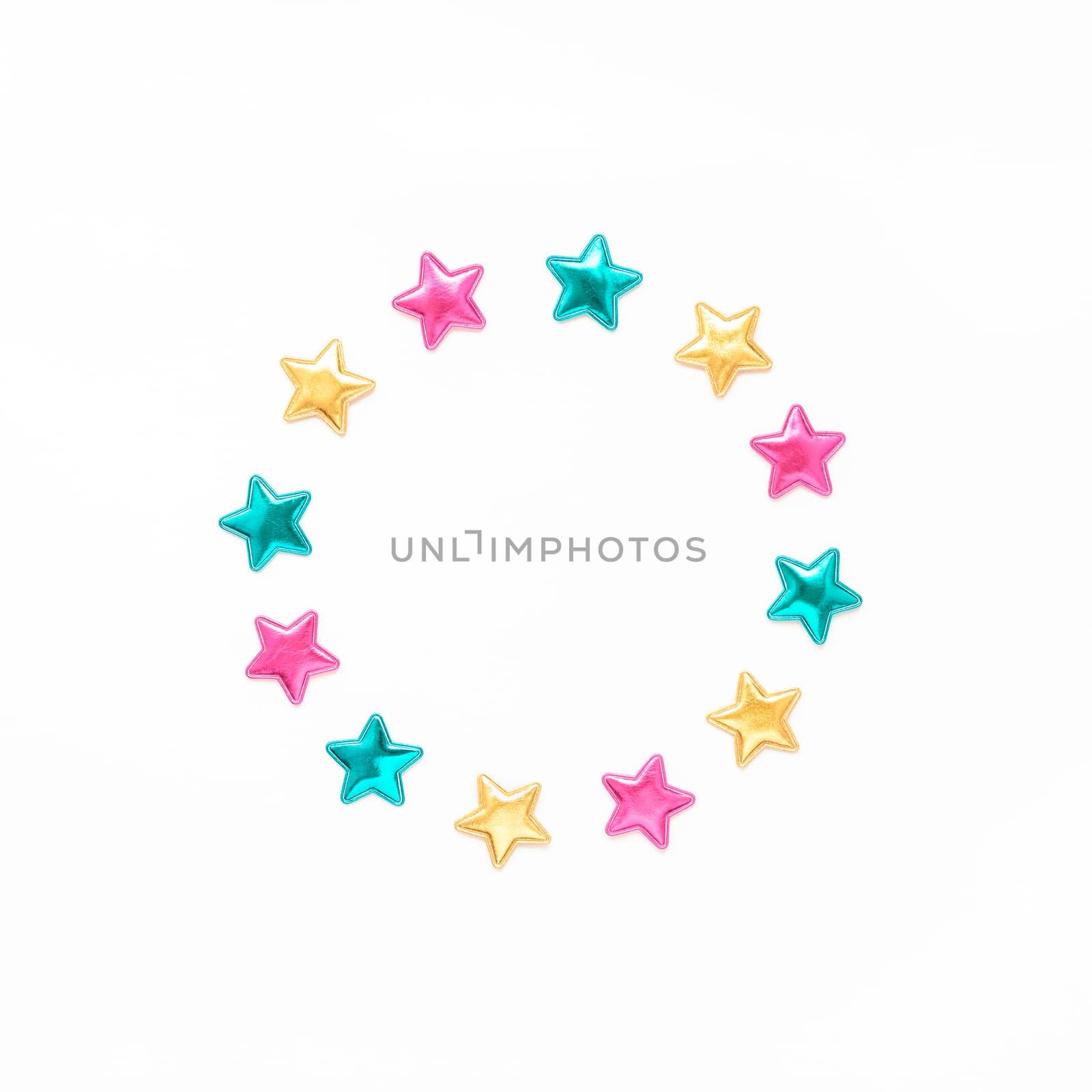 Holiday composition. New Year or Christmas pattern flat lay top view Xmas holiday celebration decorative color stars round wreath frame on white background with copy space. Template of greeting card