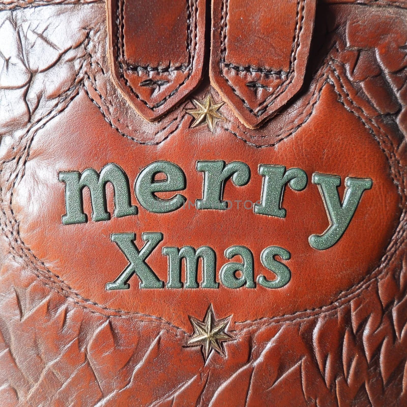 A beautifully crafted leather bag displays a festive merry Xmas message surrounded by decorative stars in vibrant colors.