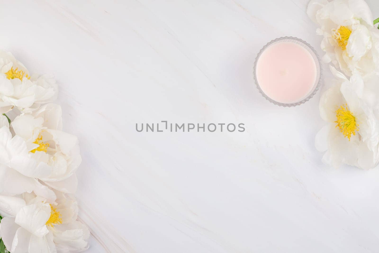 Beautiful blooming white peony flowers on marble background with copy space in minimal style, template for postcard, lettering, text or your design. Wedding invitation and celebration greeting concept