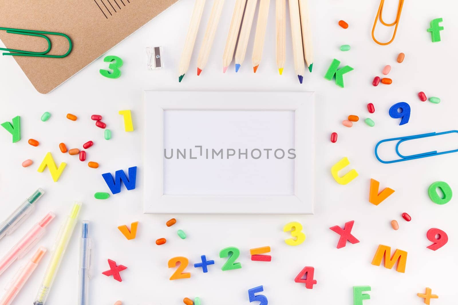 Creative flat lay back to school concept with color school and office supplies on white table background with copy space, frame, template for text or design