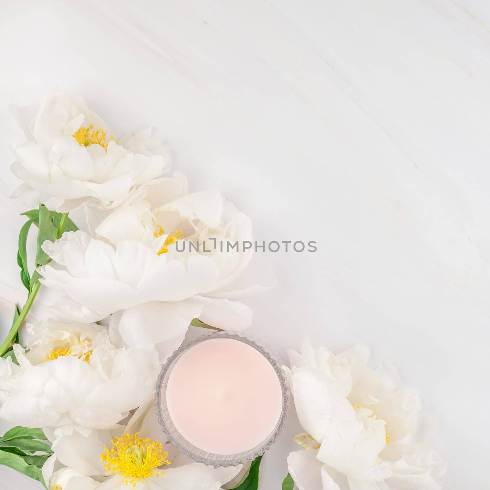 Beautiful blooming white peony flowers on marble background with copy space in minimal style, square template for postcard, text or your design. Wedding invitation and celebration greeting concept
