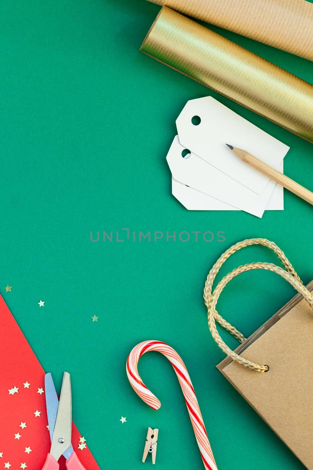 New Year or Christmas presents preparation DIY flat lay top view Xmas holiday celebration handmade gift boxes on red green paper background. Template mockup for greeting card or your text design 2019