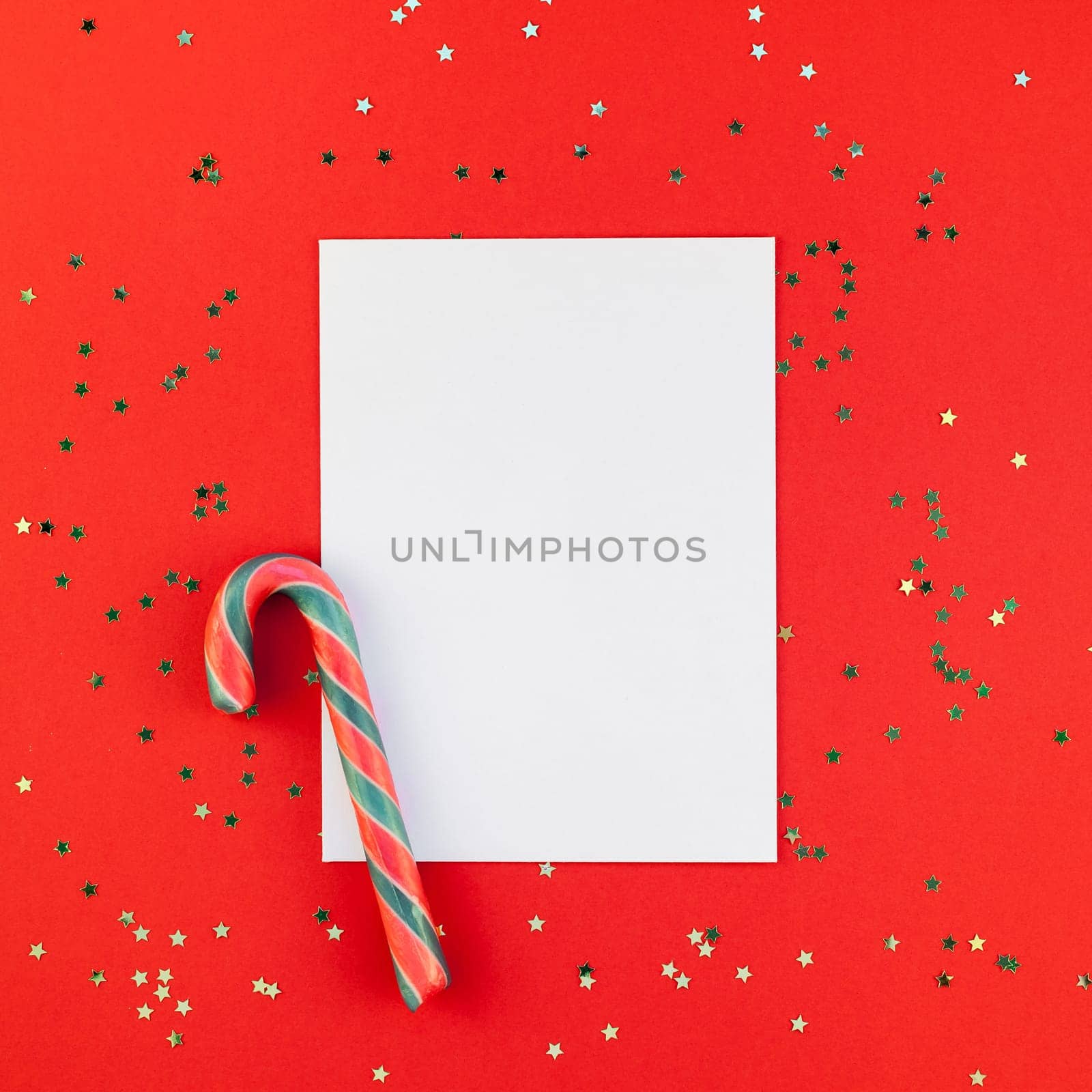 Creative New Year or Christmas greetings letter mockup flat lay top view Xmas holiday celebration envelope on red paper background golden glitter. Square Template mock up greeting card text 2019 2020