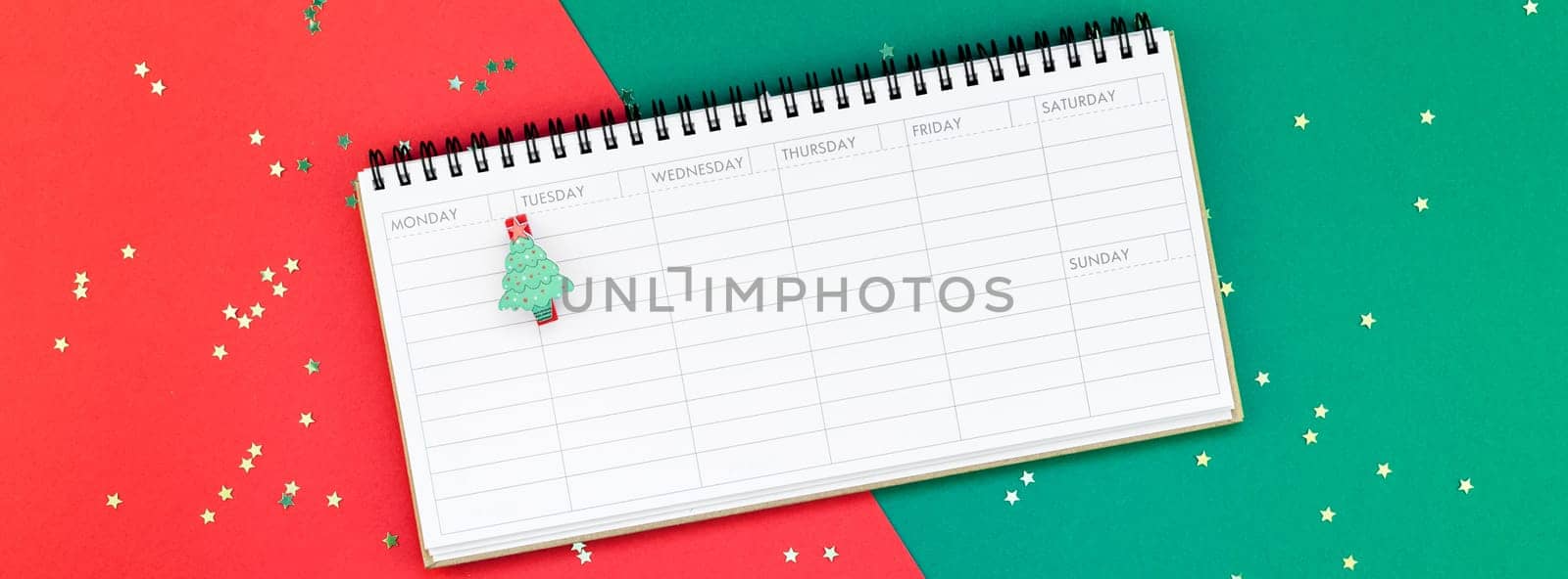 Creative New Year or Christmas timetable event planner mockup flat lay top view Xmas holiday celebration holiday schedule on red green paper background. Template mock up long wide banner 2019 2020