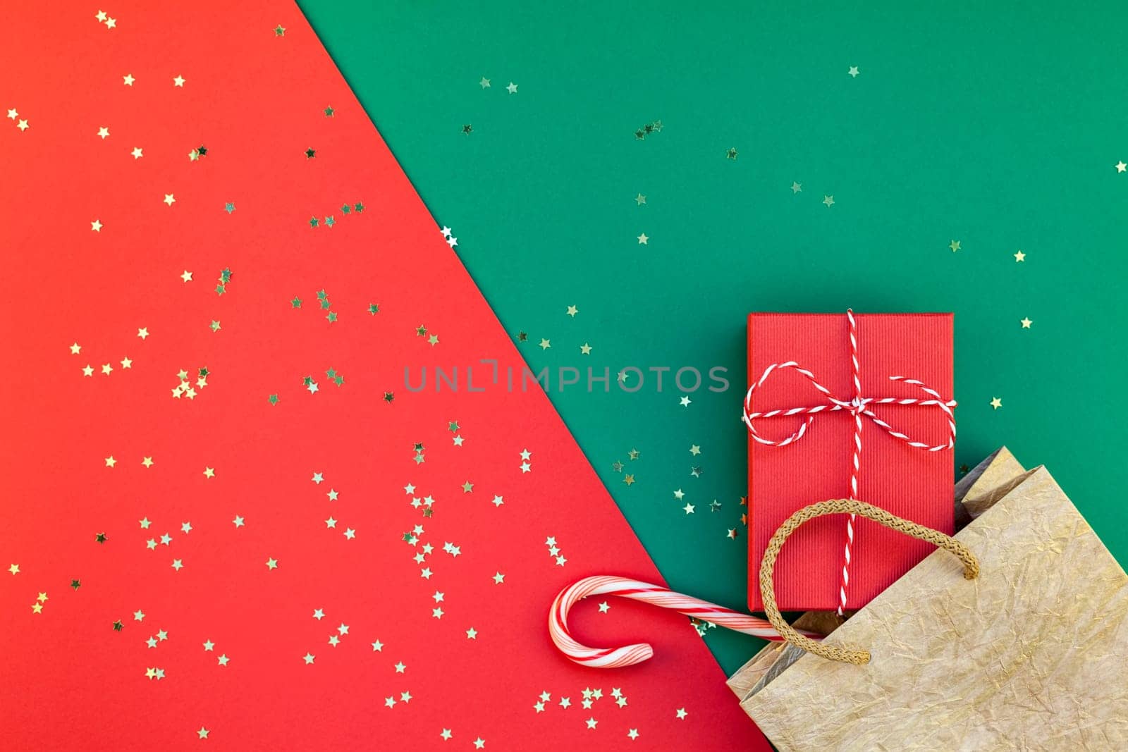 New Year or Christmas presents preparation DIY flat lay top view Xmas holiday celebration handmade gift boxes on red green paper background. Template mockup for greeting card or your text design 2019