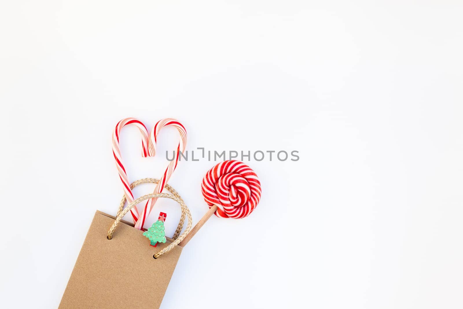 New Year or Christmas decoration flat lay top view Xmas holiday celebration shopping concept decor on white natural light background. Template frame for greeting card your design