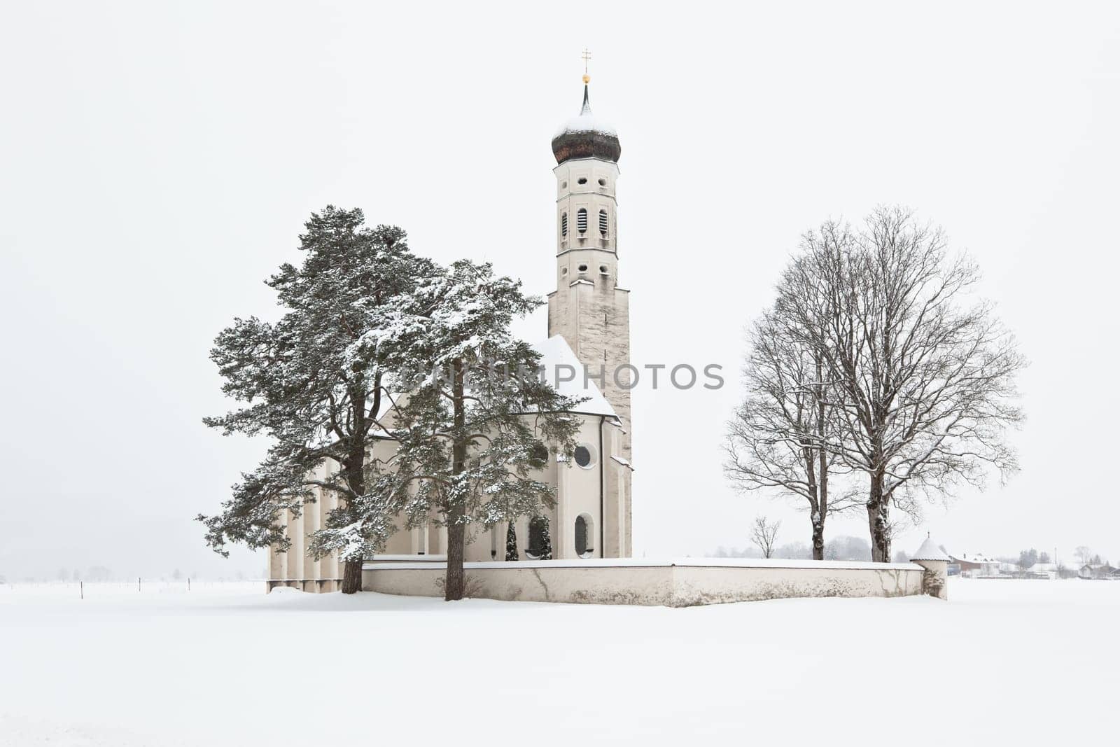 Beautiful Alpine bavarian Church after morning snowfall in mountain village