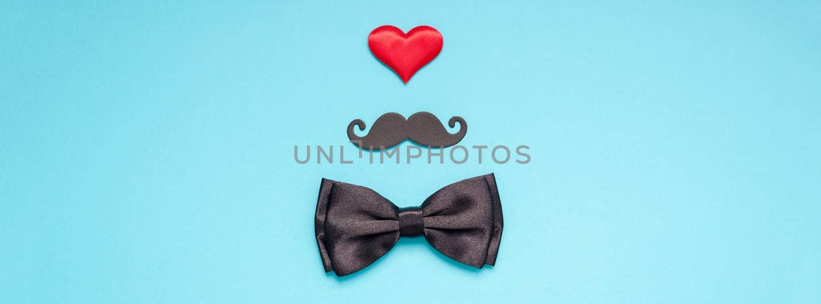Creative flatlay overhead top view retro stylish black paper moustaches bow tie red heart turquoise background copy space. Men health awareness month fathers day masculinity concept long wide banner
