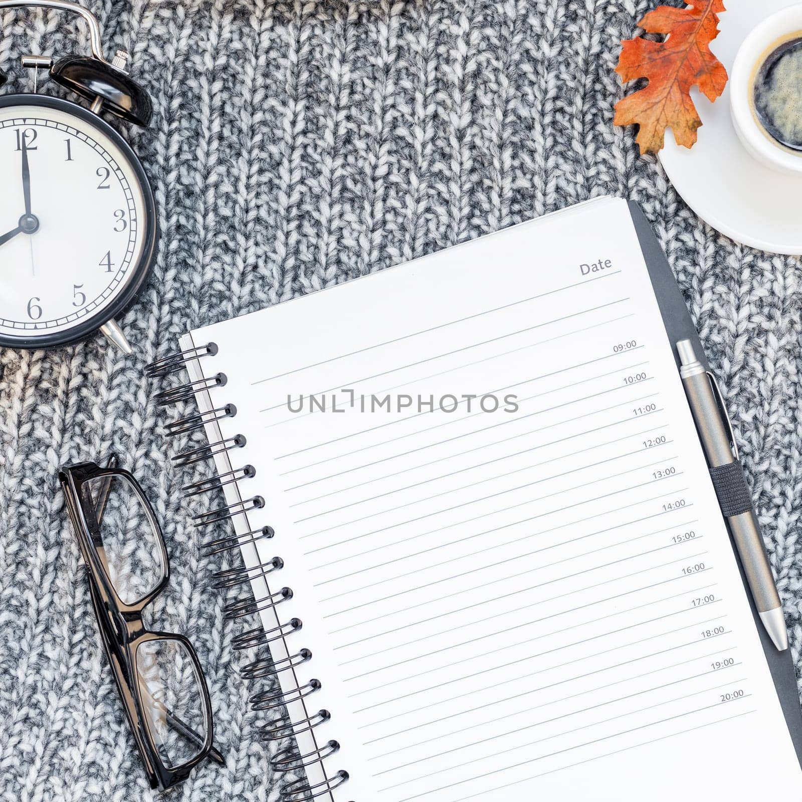 Creative square autumn flat lay overhead top view stylish home workspace planner organizer coffee cup cozy gray knitted plaid background copy space. Fall season template for feminine blog social media