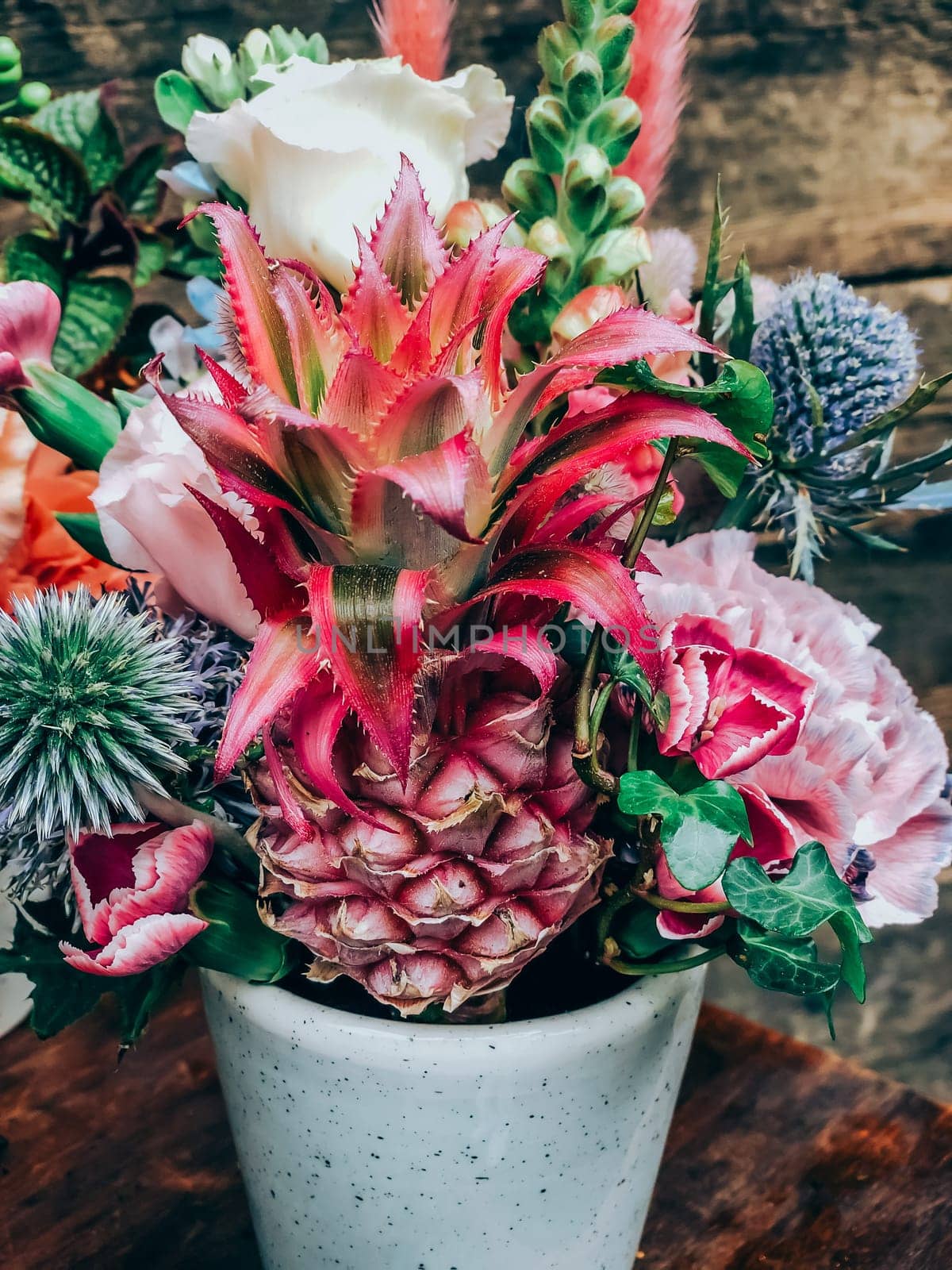 Beautiful exotic flowers bouquet in small florist shop. Modern style flowers arrangement in lifestyle natural light composition. Small business. Mobile photo