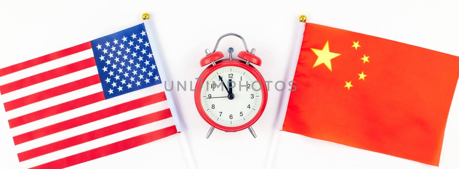 Creative top view flat lay of China and USA flag red alarm clock and copy space white background in minimal style. Concept of trade war between USA and China