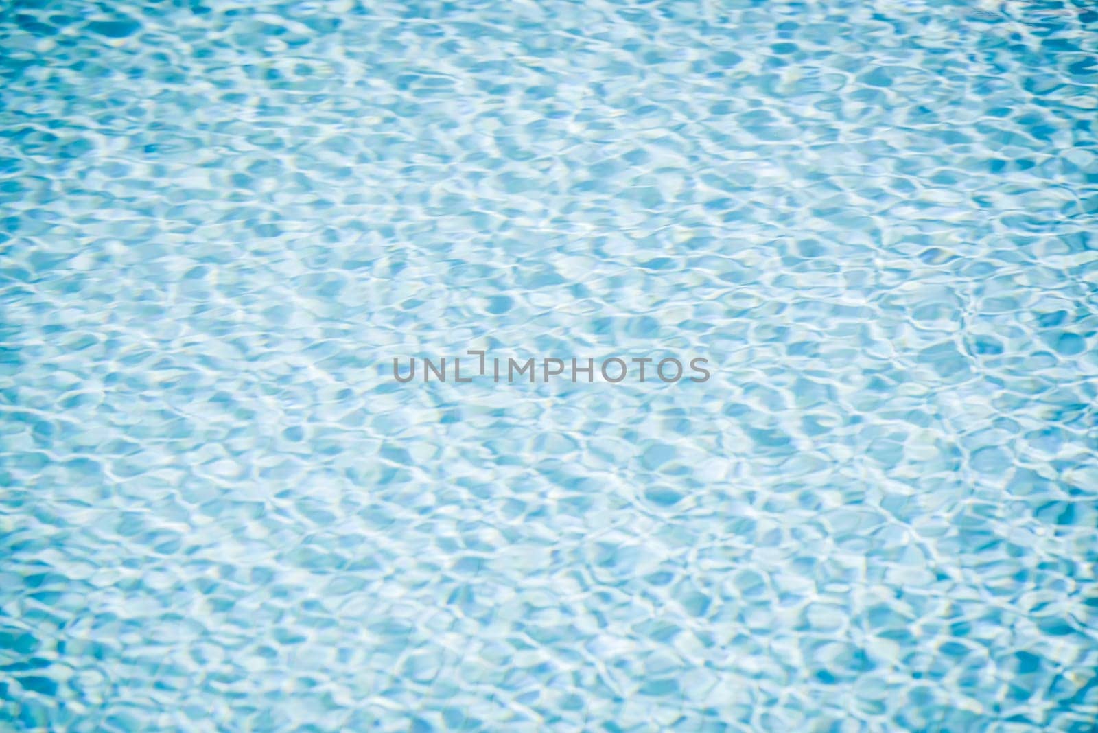 Clear transparent pool water background. Filtered blur shot