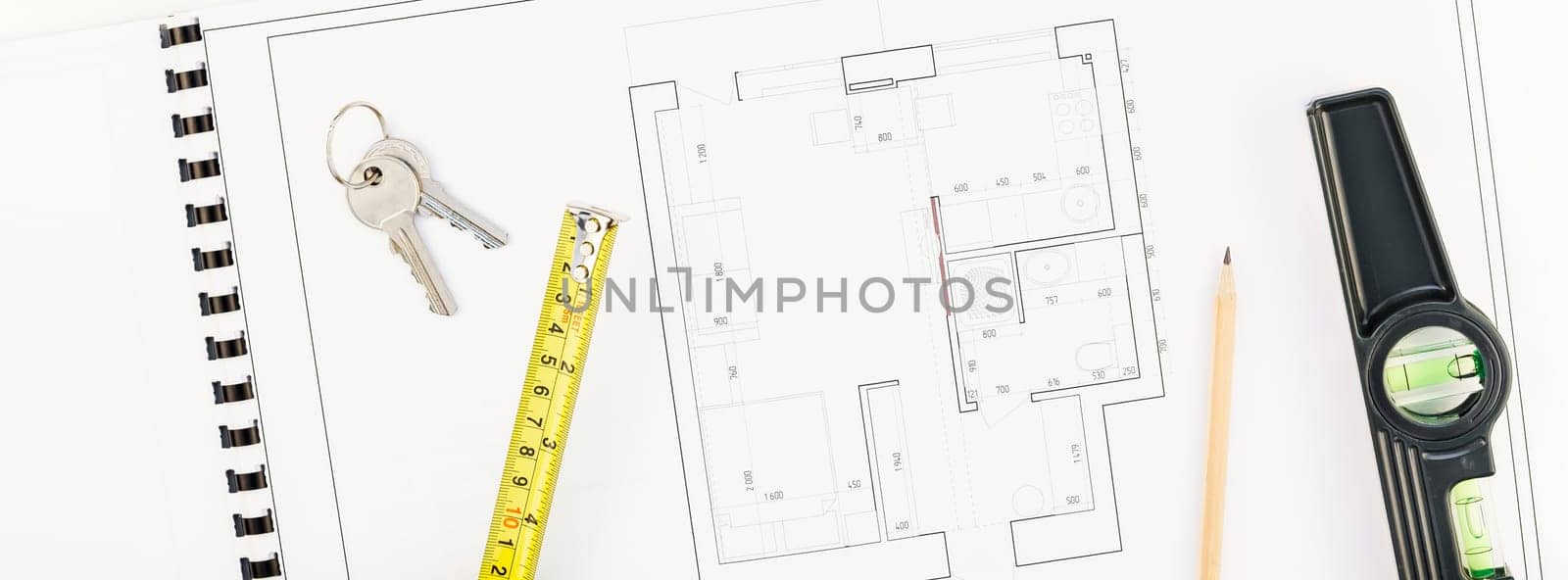 Creative flat lay overhead top view blueprint flat project plan and office supplies on decorator table workspace swatches tools and equipment background copy space concept