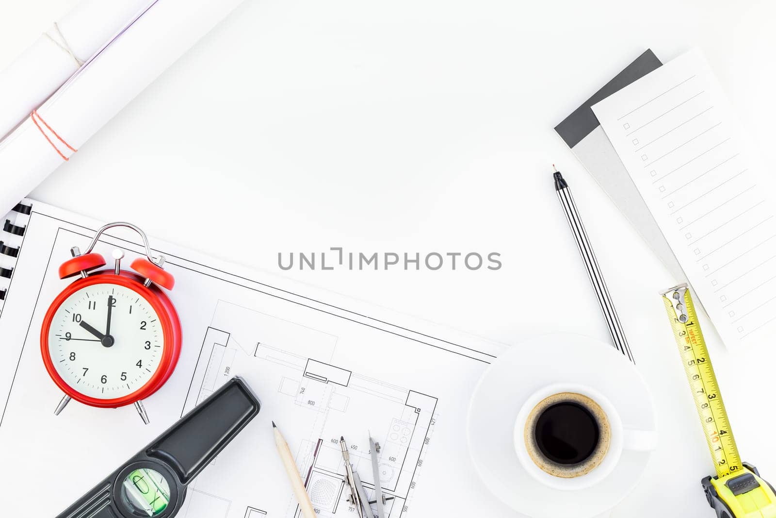 Creative flat lay overhead top view blueprint flat project plan hot coffee cup alarm clock and office supplies on decorator table workspace swatches tools and equipment background copy space concept