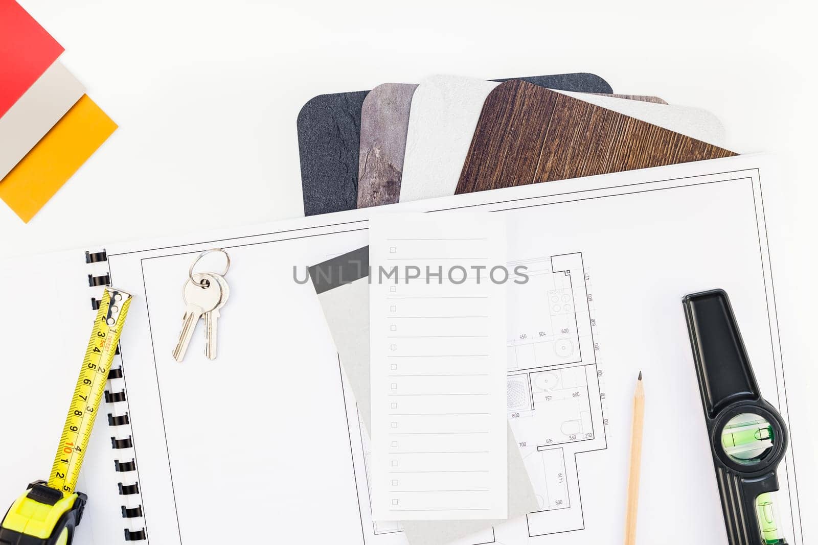 Creative flat lay overhead top view blueprint flat project plan and office supplies on decorator table workspace swatches tools and equipment background copy space concept