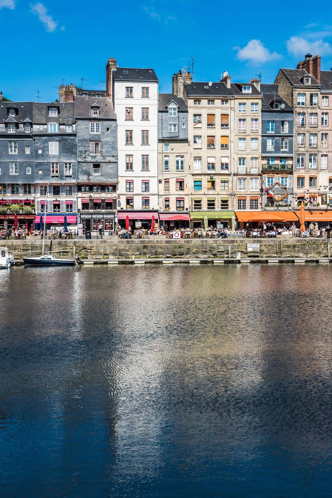FRANCE, HONFLEUR - MAY 30: Honfleur harbour in Normandy, France. Color houses and their reflection in water on May 30, 2015