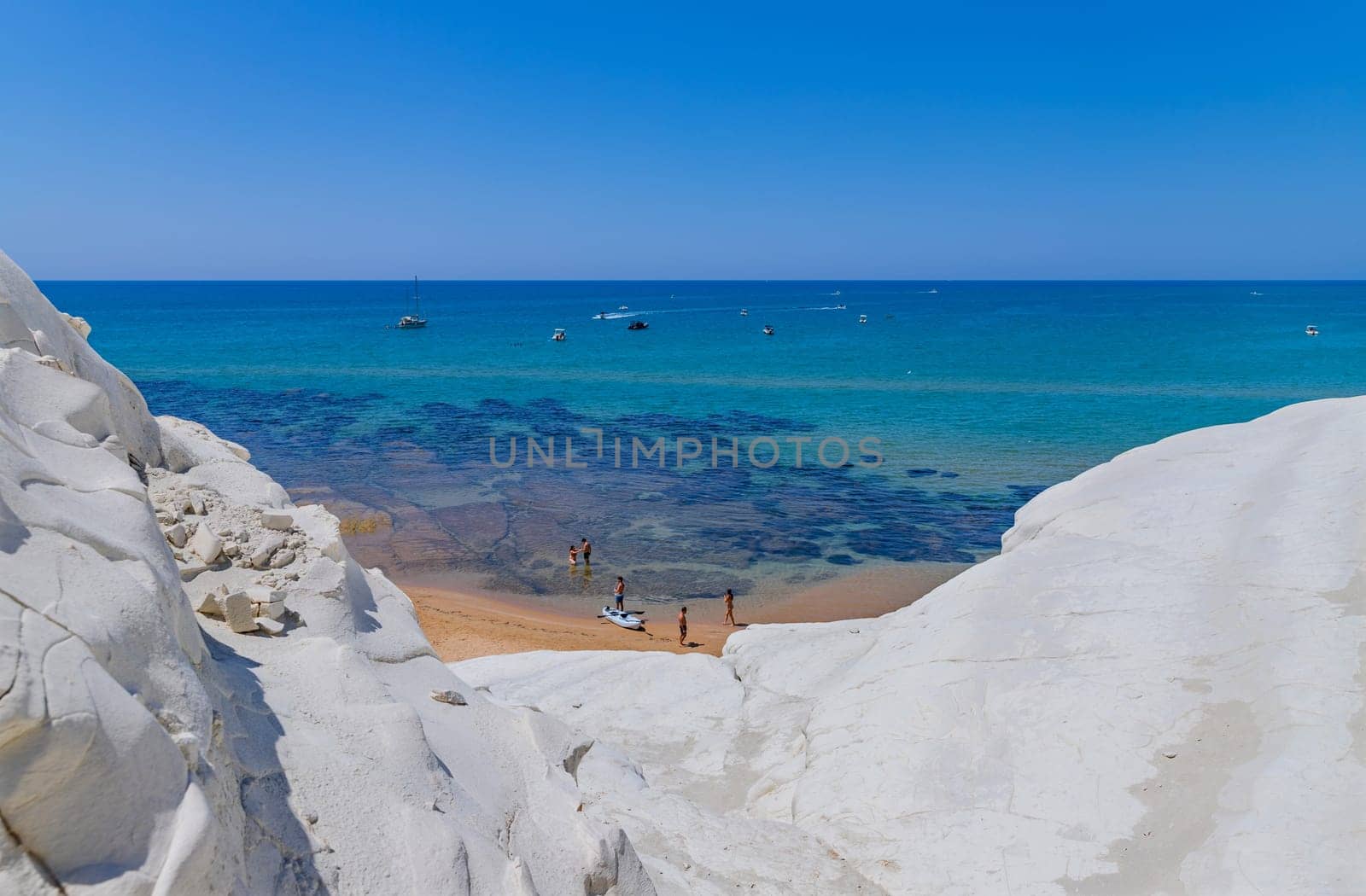 Sicily, Italy: August 9, 2024: Some people at the Beach of Scala dei Turchi (Stair of the Turks) in Sicily, Italy