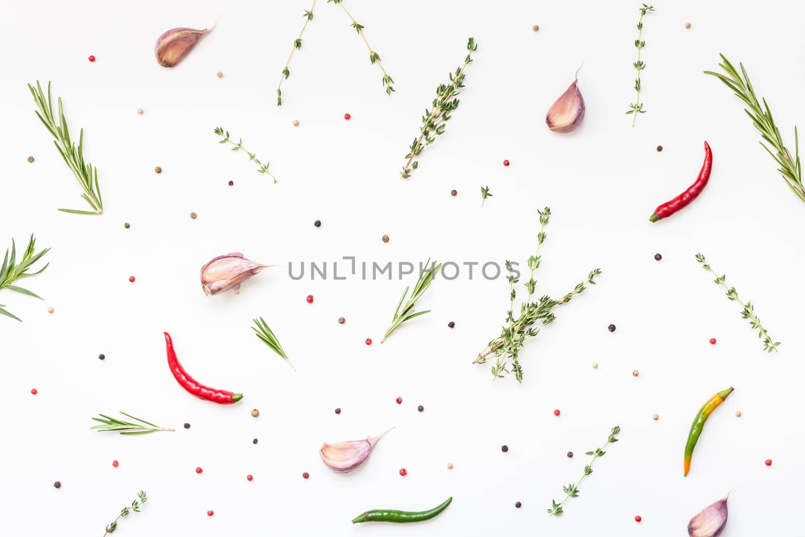 Flat lay overhead top view of greens herbs and spices on white background with copy space. Menu frame design food pattern background with cooking ingredients