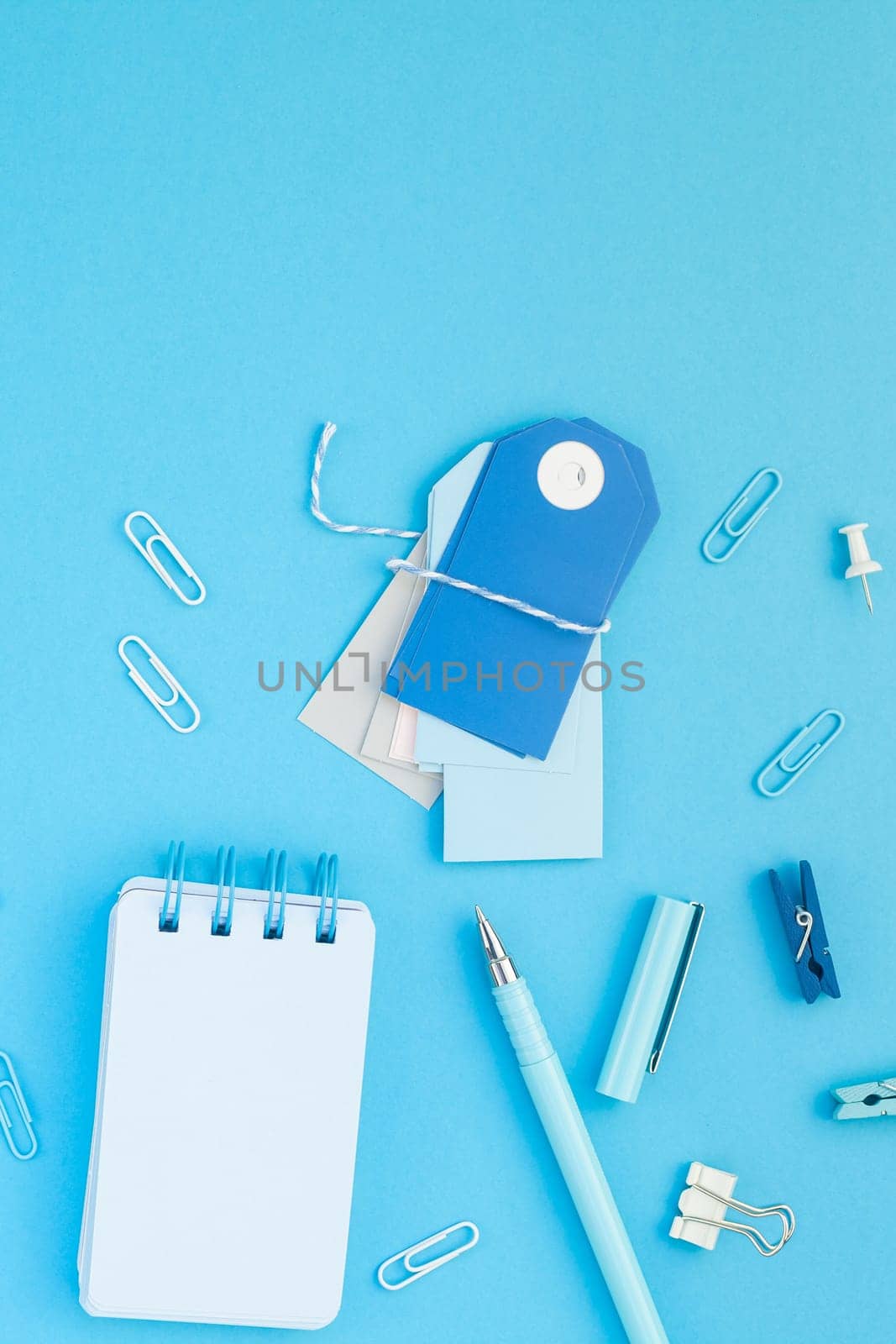 Top view flat lay of workspace desk styled design school and office supplies with copy space turquoise blue color paper background minimal style. Template for feminine blog social media