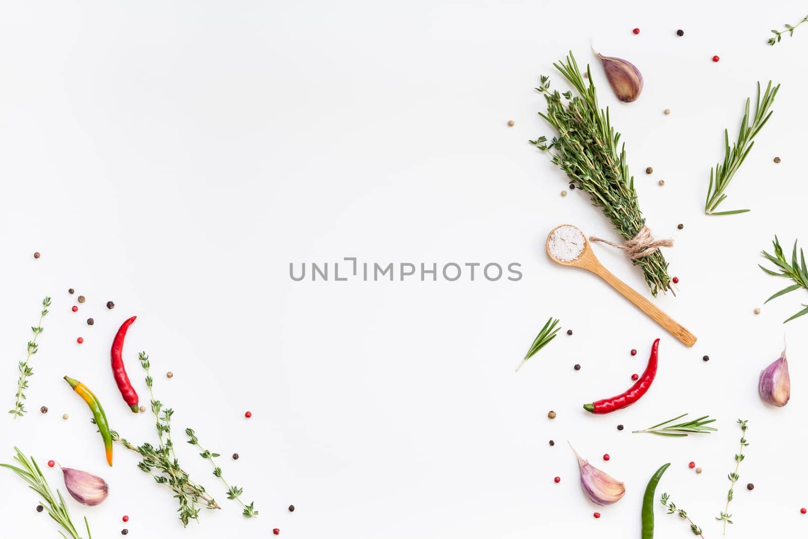Flat lay overhead top view of greens herbs and spices on white background with copy space. Menu frame design food pattern background with cooking ingredients