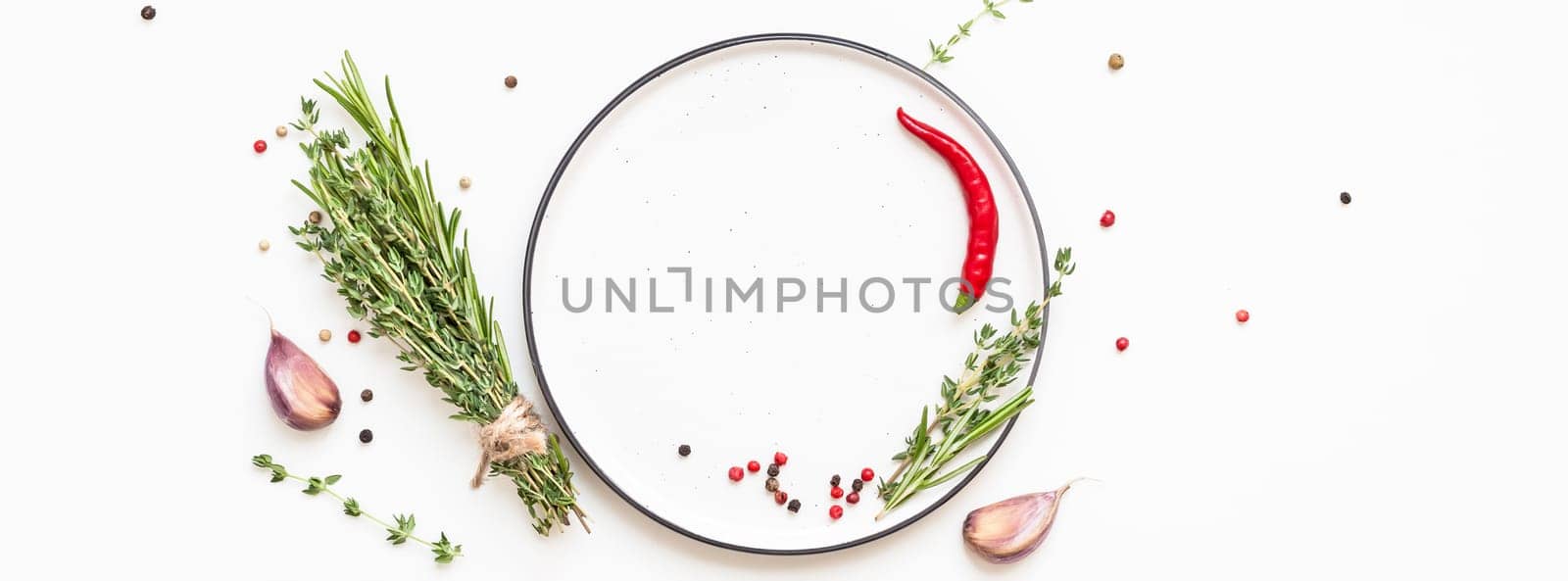 Flat lay overhead view empty plate mockup blank text space invitation card on white background with greens herbs and spices. Menu design food background with cooking ingredients