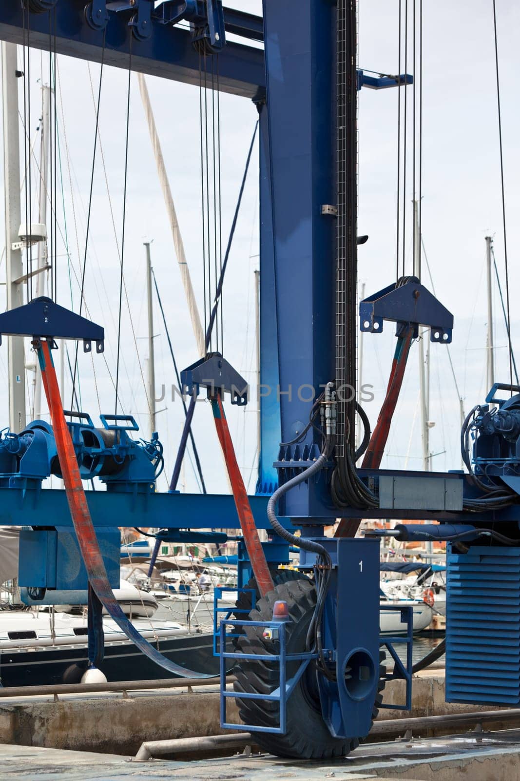 Big crane for a ship maintenance in a marina. Vertical shot
