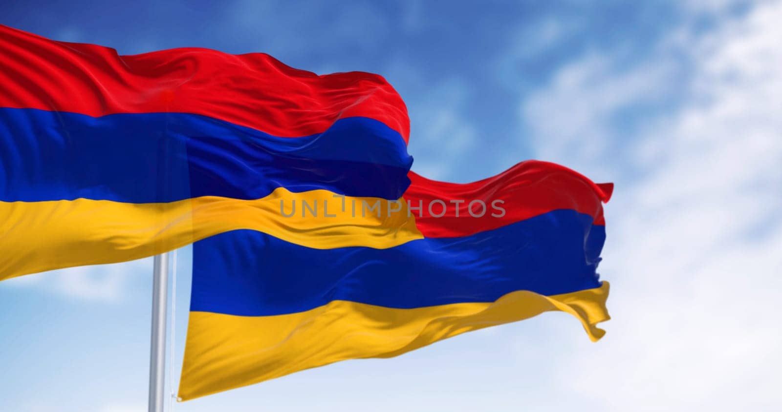 Three Armenia national flags waving in the wind. Three horizontal bands in red, blue and apricot. 3d illustration render. Rippled fabric. Selective focus