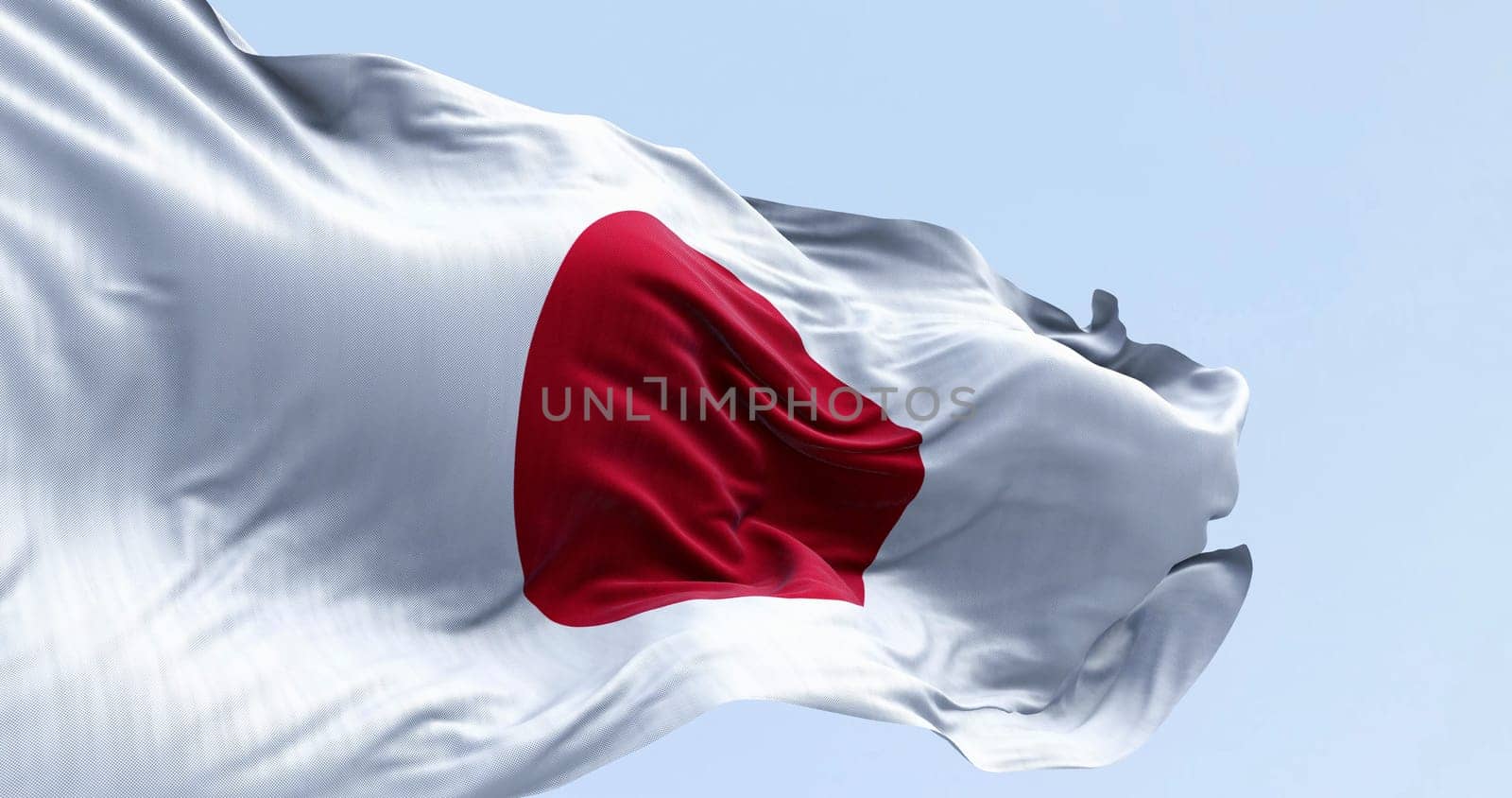 Japan national flag waving in the wind on a clear day. Red disc on a white field. Japan is an island country in East Asia. 3D illustration render. Rippled textile. Selective focus. Waving flag