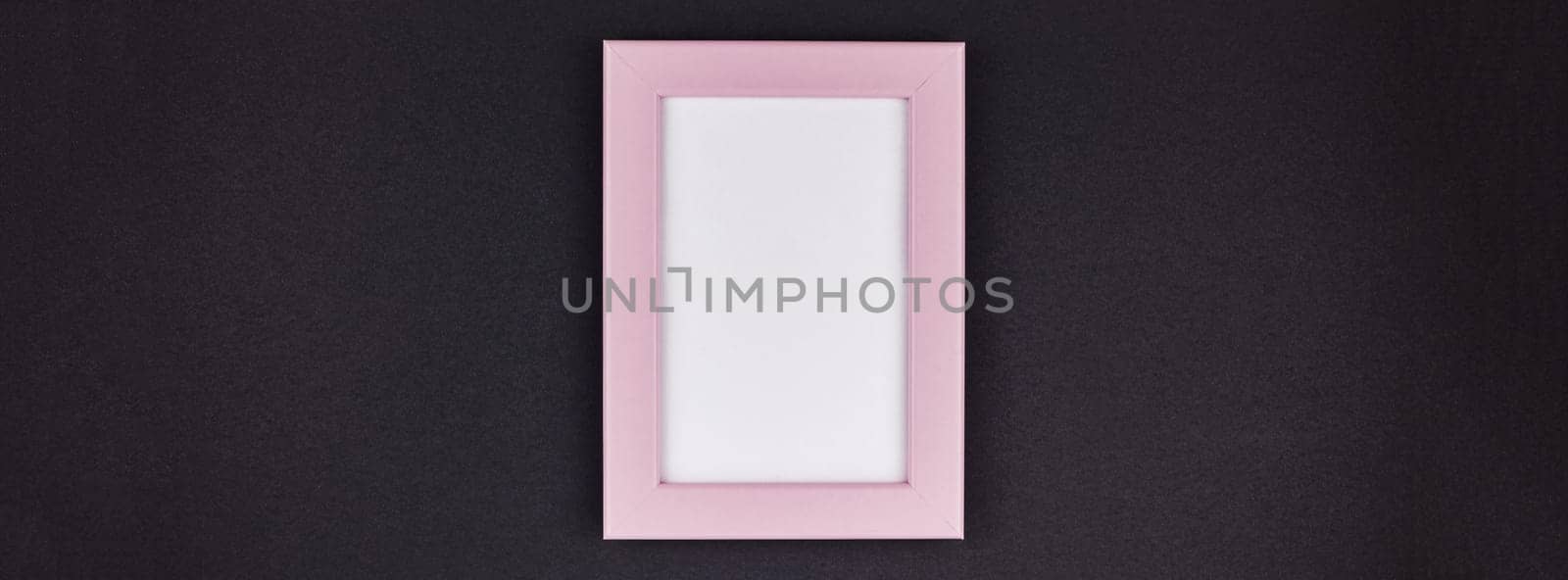 Mock up of a millennial pink frame on dark black color paper background with copy space in minimal style, template for text or your image mockup. Long wide banner