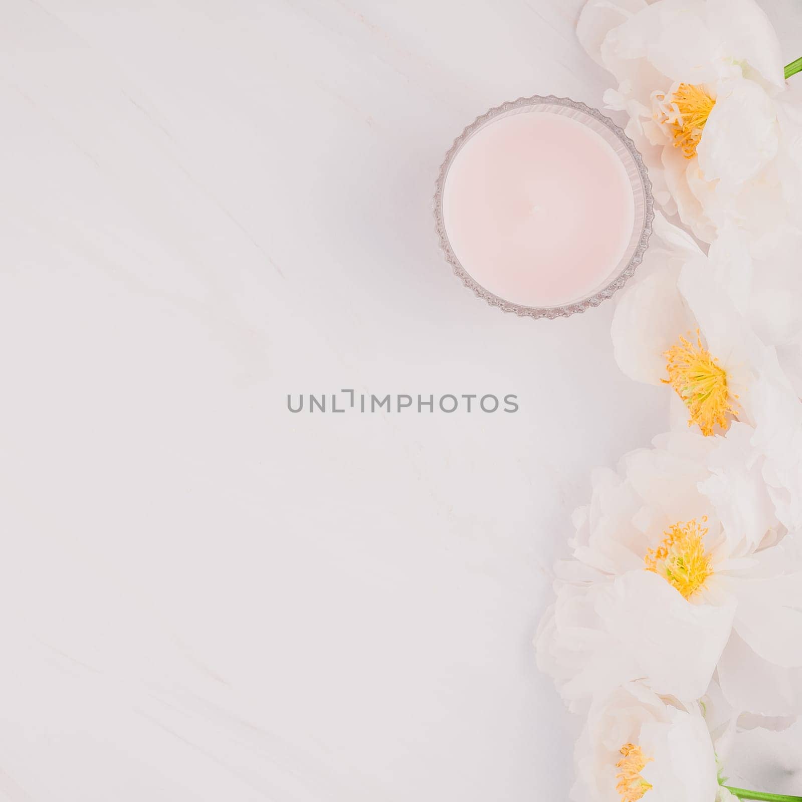 Beautiful blooming white peony flowers on marble background with copy space in minimal style, square template for postcard, text or your design. Wedding invitation and celebration greeting concept