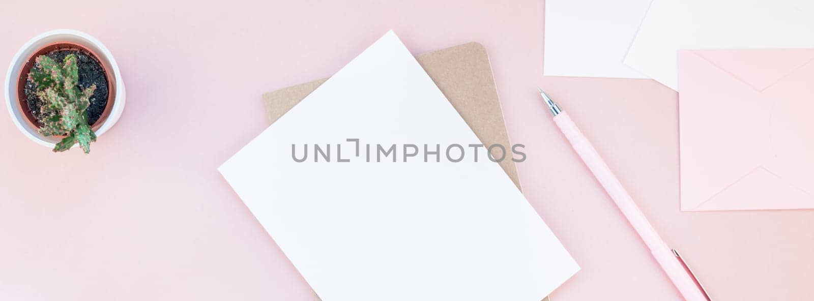 Long wide banner of workspace desk styled design office supplies and cactuses succulents with copy space millennial pink color paper background minimal style. Template for feminine blog social media