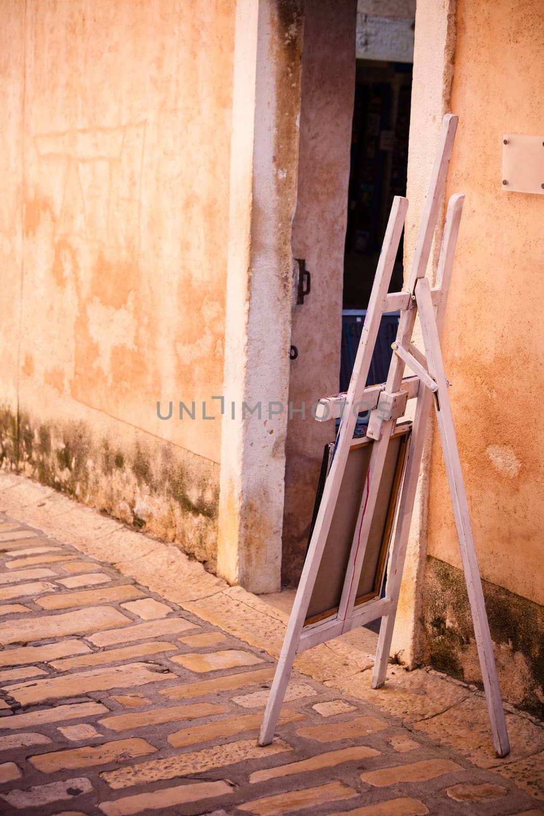 Selling of paintings on a street of an old town in the Southern Europe. Sunny day