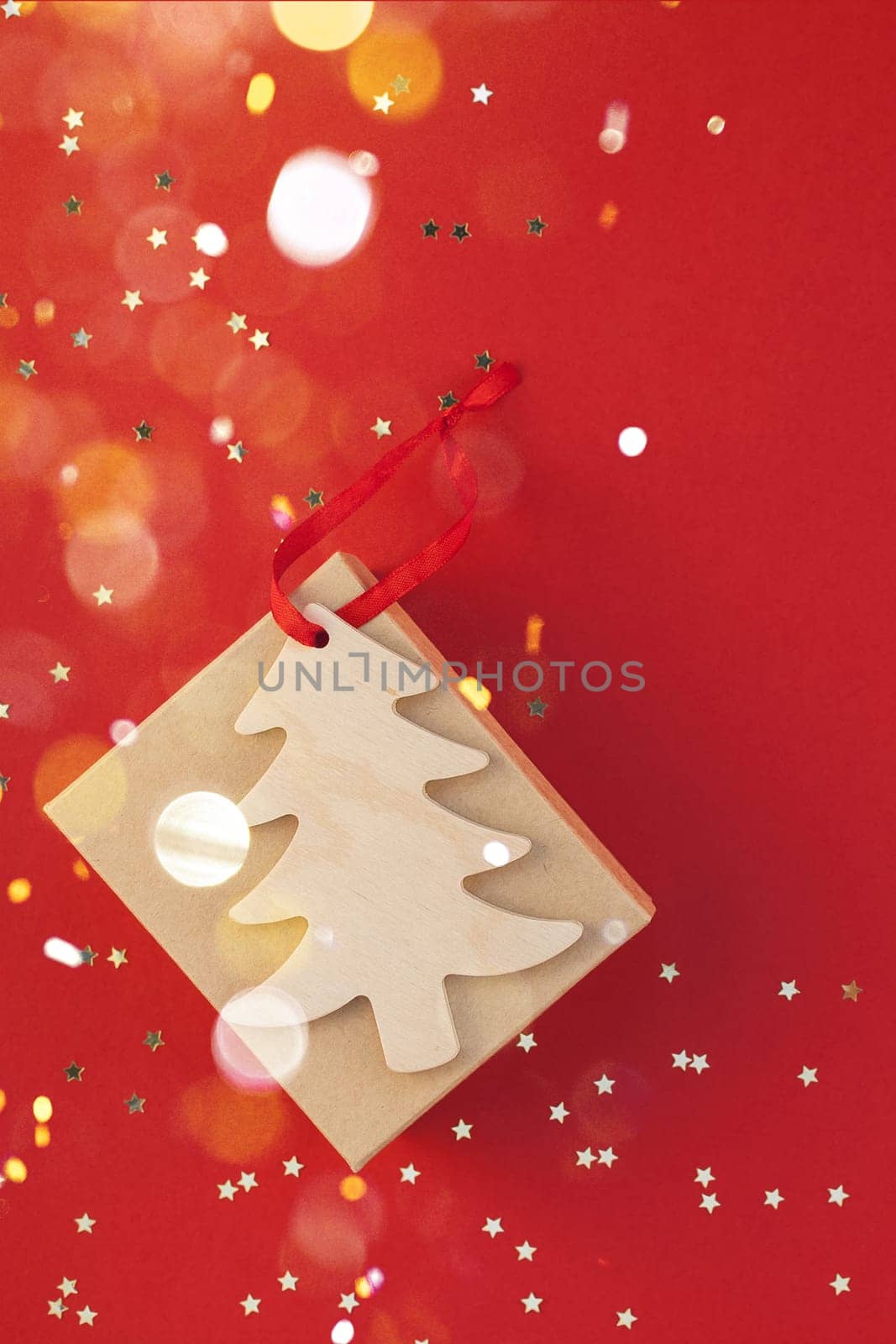 New Year or Christmas present flat lay top view Xmas holiday 2020 celebration handmade gift box red paper golden sparkles background copyspace. Template mockup for greeting card text design