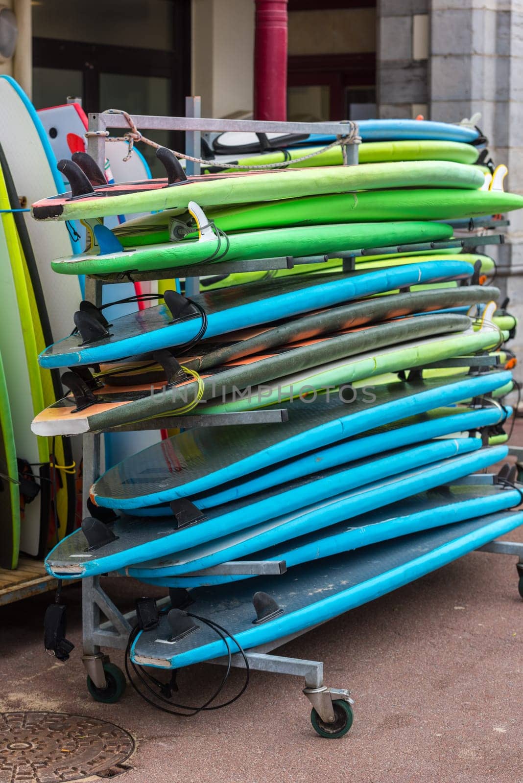 set of different color surf boards in a stack. France