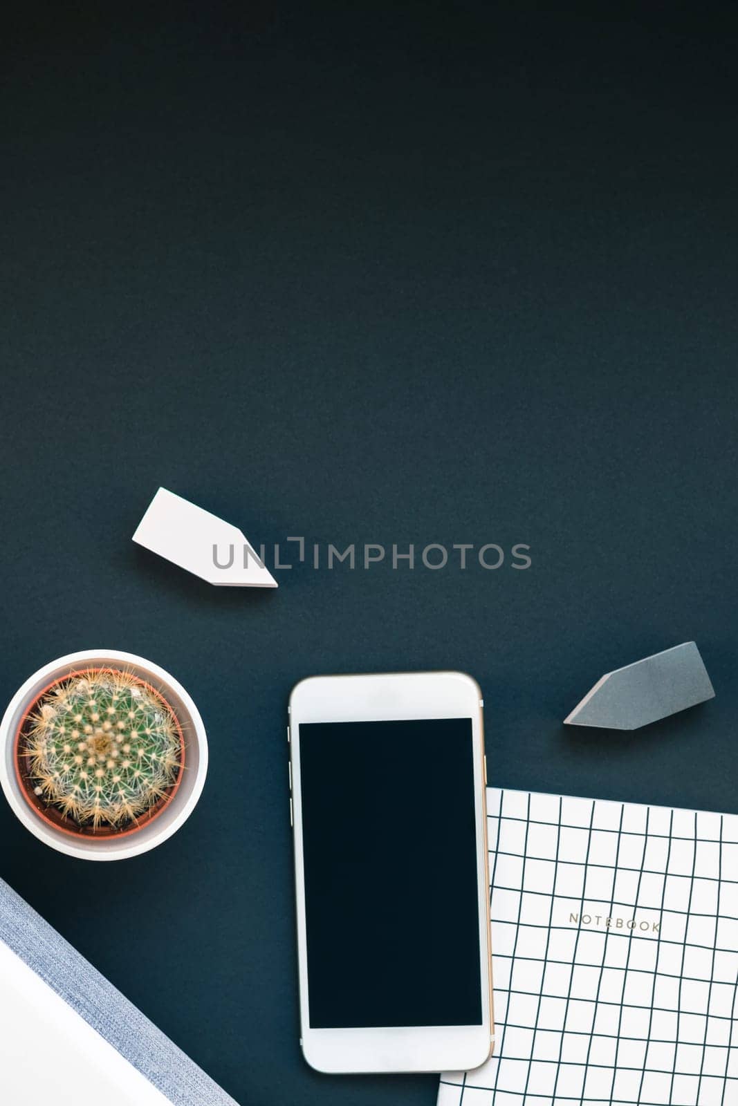Top view flat lay of feminine desk workspace with white stereo bluetooth soundbar and smartphone for music listening with copy space on black background. Template for blog social media