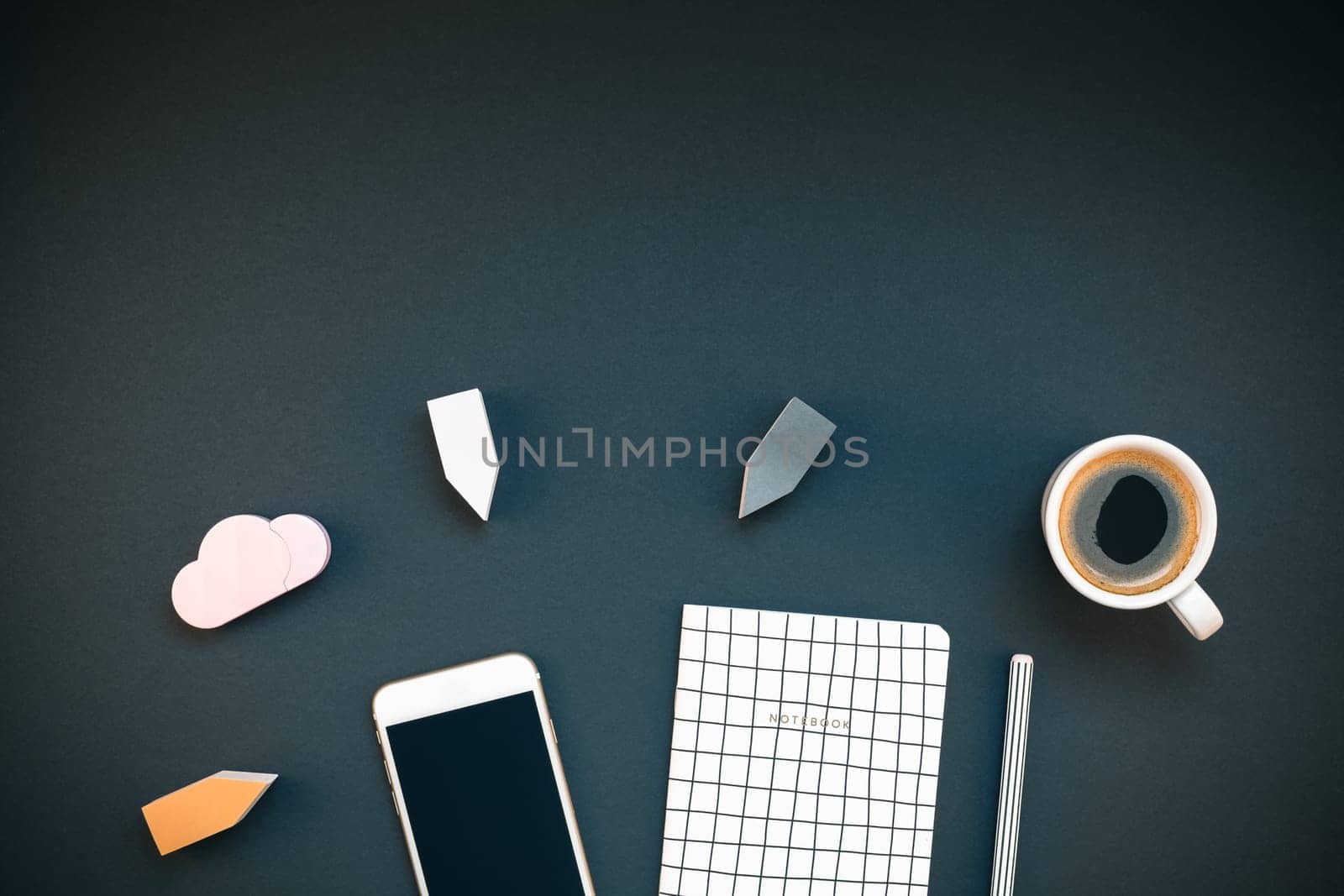 Top view flat lay feminine desk workspace with coffee, smartphone and office supplies with copy space on black background. Creative template for blog social media