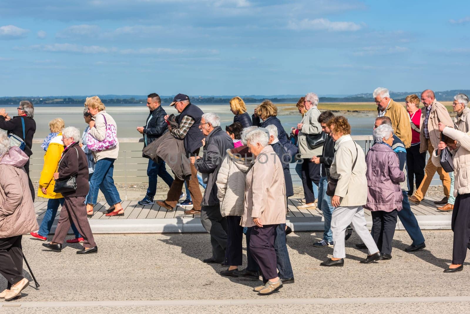 FRANCE, MONT SAINT MICHEL - SEPTEMBER 26: Old people visiting Mont Saint Michel monastery, Brittany, France on September 26, 2015