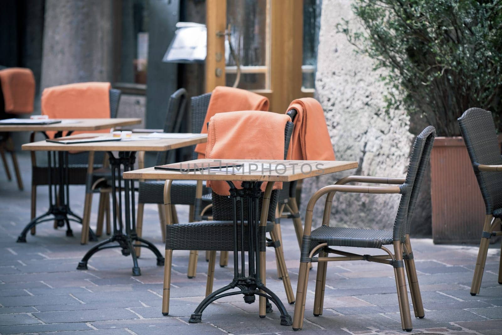 Outdoor street cafe tables ready for service. Small GRIP toned shot