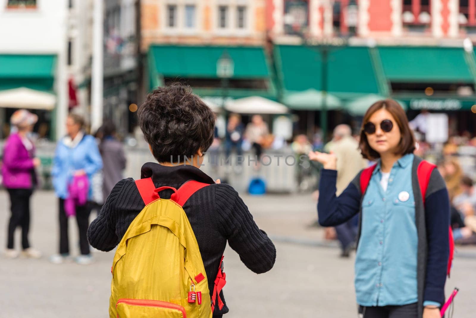 BELGIUM, BRUGES - MAY 22: Woman is taking pictures on the street of Bruges on May 22, 2015