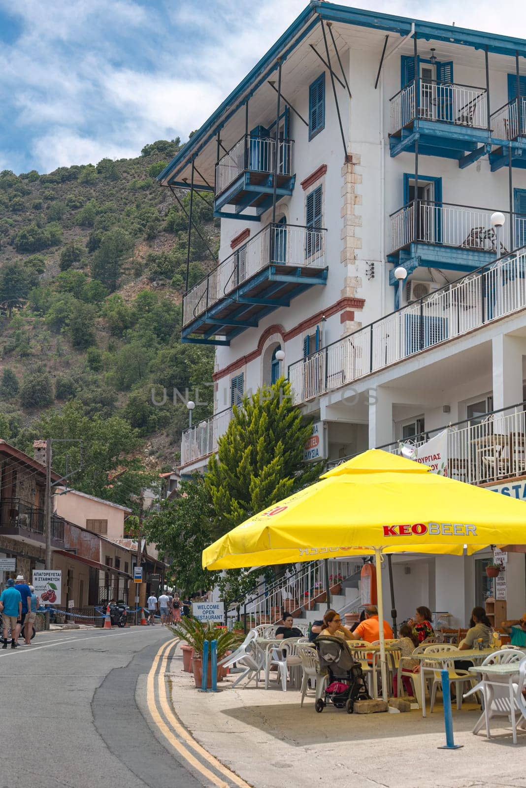 Pedoulas, Limassol District, Cyprus - June 11, 2023: Tourists relaxing at cafe in Pedoulas, a Popular destination in Troodos mountains famous for its Byzantine churches and delicious cherries