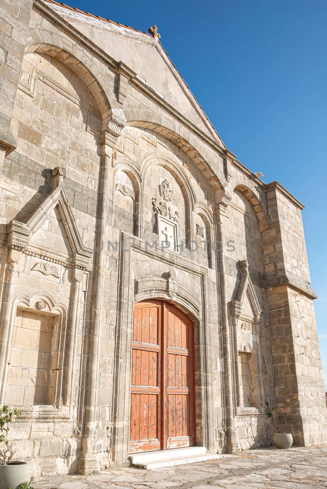 The Timios Prodromos church in Vouni village, Limassol District, Cyprus is displaying its weathered wooden doors on a sunny day